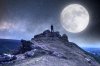 man-standing-top-hill-looking-out-sky-full-moon-stars-147072322.jpg